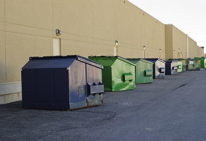 an assortment of sturdy and reliable waste containers near a construction area in Lillian